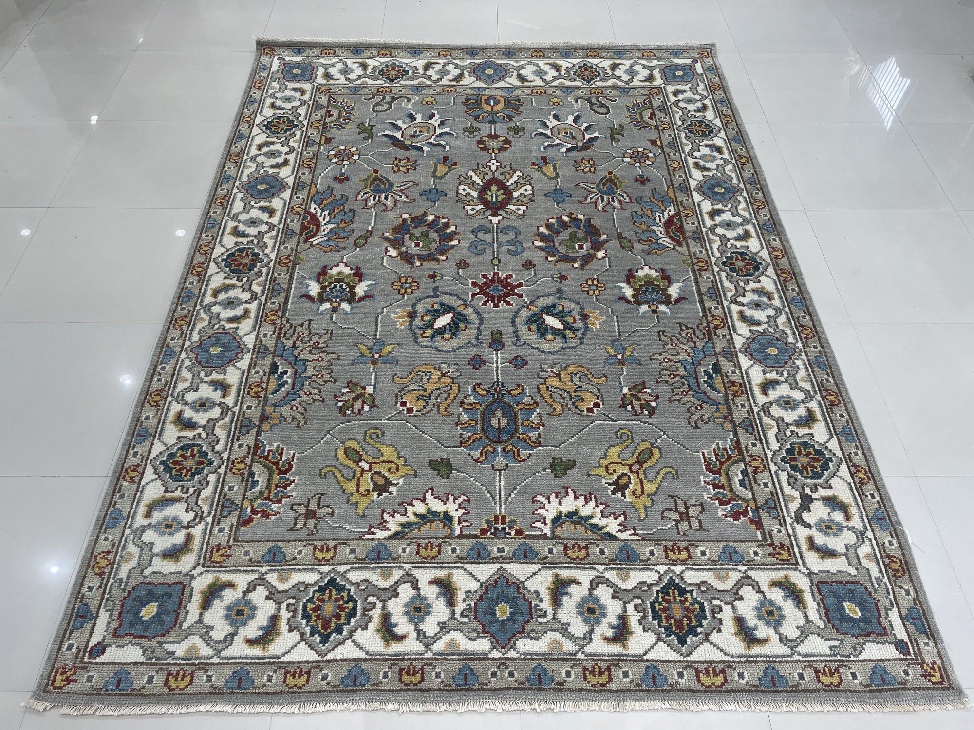 Enchanting Oriental Gray Hand Knotted Wool Rug, showcasing intricate traditional patterns in muted gray tones, hand-knotted wool construction with subtle variations in texture, presented as a detailed close-up view.