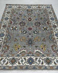 Enchanting Oriental Gray Hand Knotted Wool Rug, showcasing intricate traditional patterns in muted gray tones, hand-knotted wool construction with subtle variations in texture, presented as a detailed close-up view.