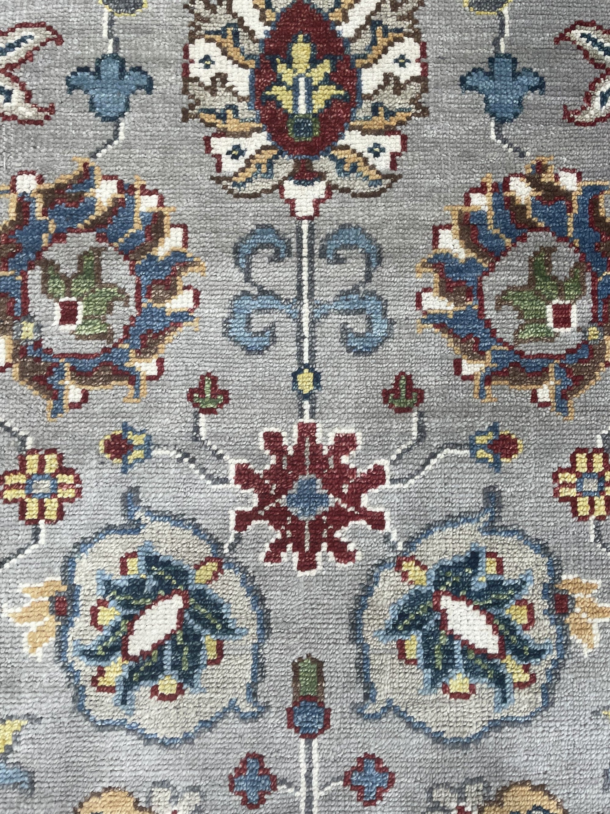 Enchanting Oriental Gray Hand Knotted Wool Rug, a gray wool rug with an intricate Oriental pattern, seen from a slightly elevated angle.