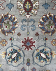 Enchanting Oriental Gray Hand Knotted Wool Rug, a gray wool rug with an intricate Oriental pattern, seen from a slightly elevated angle.