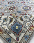 Enchanting Oriental Gray Hand Knotted Wool Rug, displaying intricate patterns in shades of gray, likely in a room setting to show scale and possible coordination with furniture.