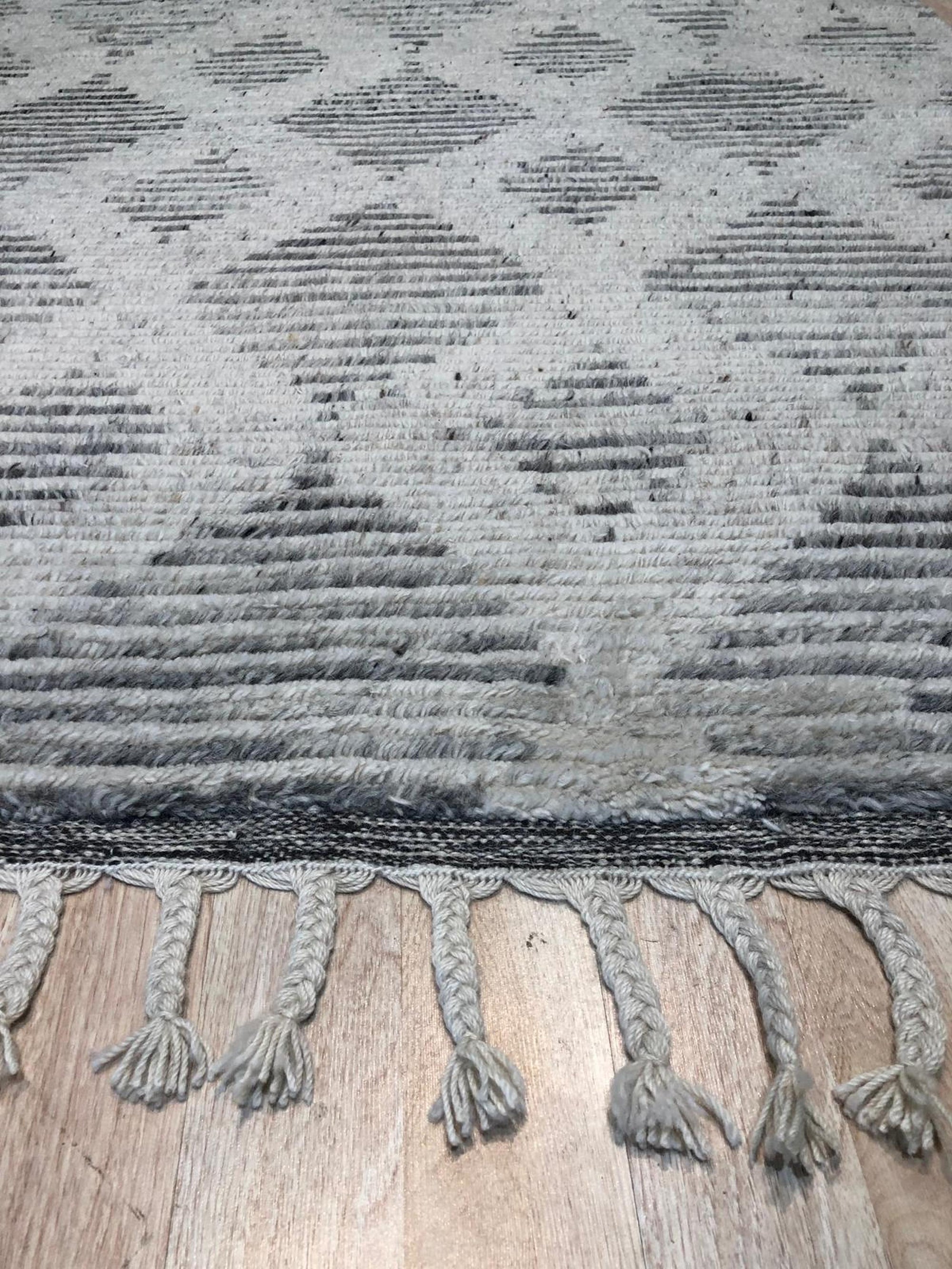 Dazzling Ophelia Beige Hand Knotted Wool Rug, showcasing its intricate hand-knotted construction and warm beige tones, displayed within a styled living room setting.