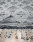 Dazzling Ophelia Beige Hand Knotted Wool Rug, showcasing its intricate hand-knotted construction and warm beige tones, displayed within a styled living room setting.