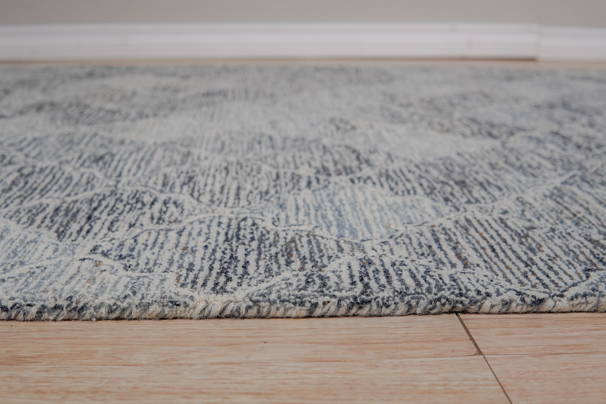 Zinnia Kira Multicolor Hand Tufted Wool Rug, its vibrant hues and plush texture grounding a modern living space, details showcasing the rug's hand-tufted construction and energetic floral pattern.