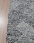 Zinnia Kira Multicolor Hand Tufted Wool Rug displayed in a brightly lit room. The rug’s vibrant palette and bold floral design energize the space, complementing the contemporary furniture. Hand tufted wool construction promises both comfort and durability.