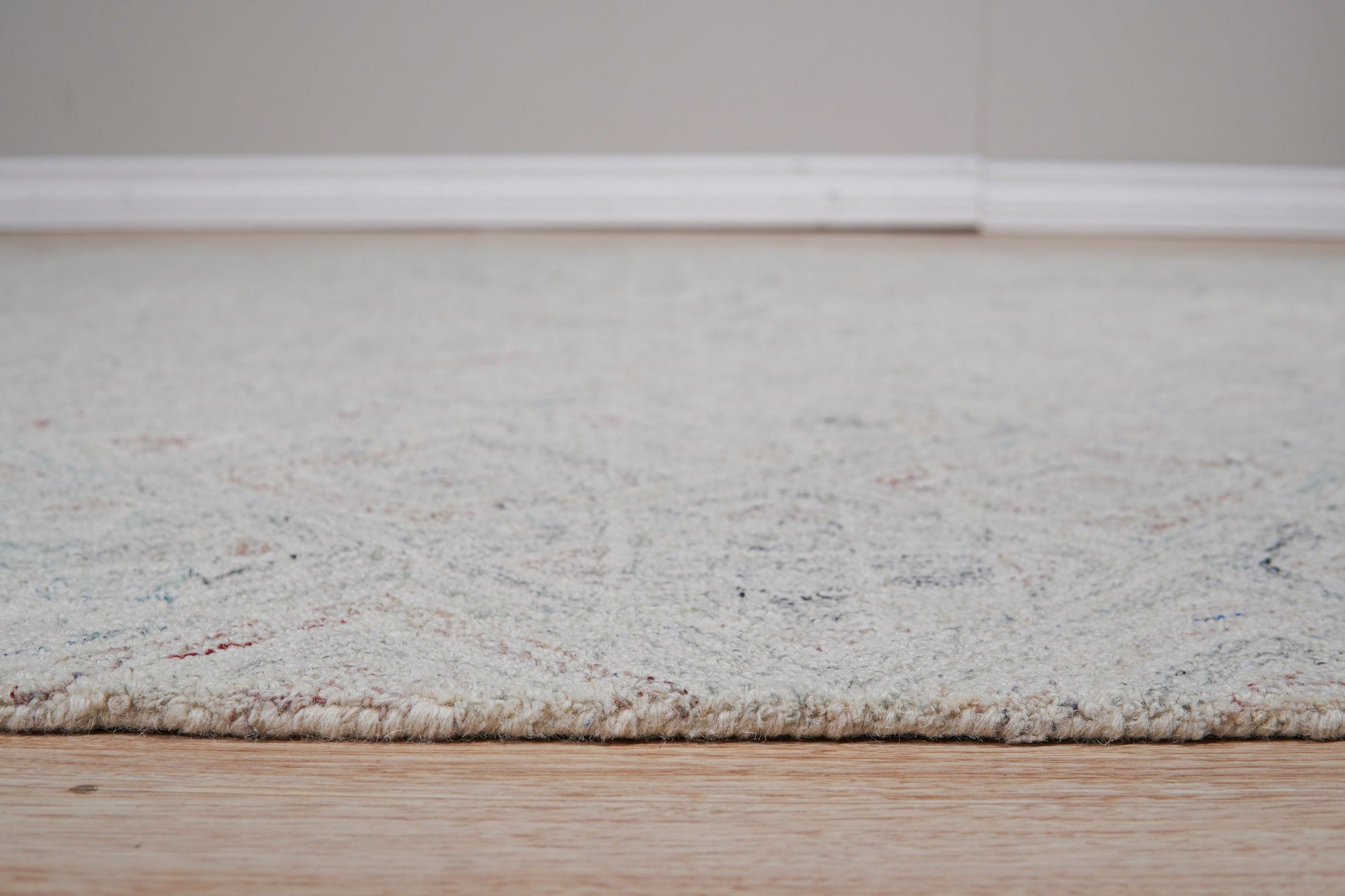 Since the image position is 3, here's the alt text:
 
 Amara Nina Multicolor Hand Tufted Wool Rug, vibrant hues blending in a textured wool field, softening a brightly lit living space.