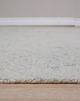 Since the image position is 3, here's the alt text:
 
 Amara Nina Multicolor Hand Tufted Wool Rug, vibrant hues blending in a textured wool field, softening a brightly lit living space.