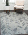 Kira Cassandra Gray Hand Tufted Wool Rug, its textured gray wool blooms across a living room floor, offering subtle pattern and plush comfort.