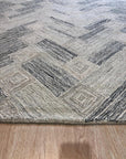 Kira Cassandra Gray Hand Tufted Wool Rug, a plush gray wool rug with subtle textural variations, displayed in a living room setting with contemporary furniture.