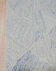 Para Nadia Blue Hand Tufted Wool Rug, a calming expanse of blue wool, presents a subtly textured surface in a detailed close-up view of the rug.