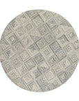 Nina Rustic Gray Hand Tufted Wool Rug, showcasing soft textures and subtle gray tones, lies flat on a light surface, its hand-tufted construction evident in its plush pile.