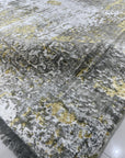 Chic Iris Gold Hand Knotted Wool Rug, showcasing shimmering gold hues and an intricate iris-inspired design in a lifestyle setting. Hand-knotted wool construction adds texture and luxury to the room.