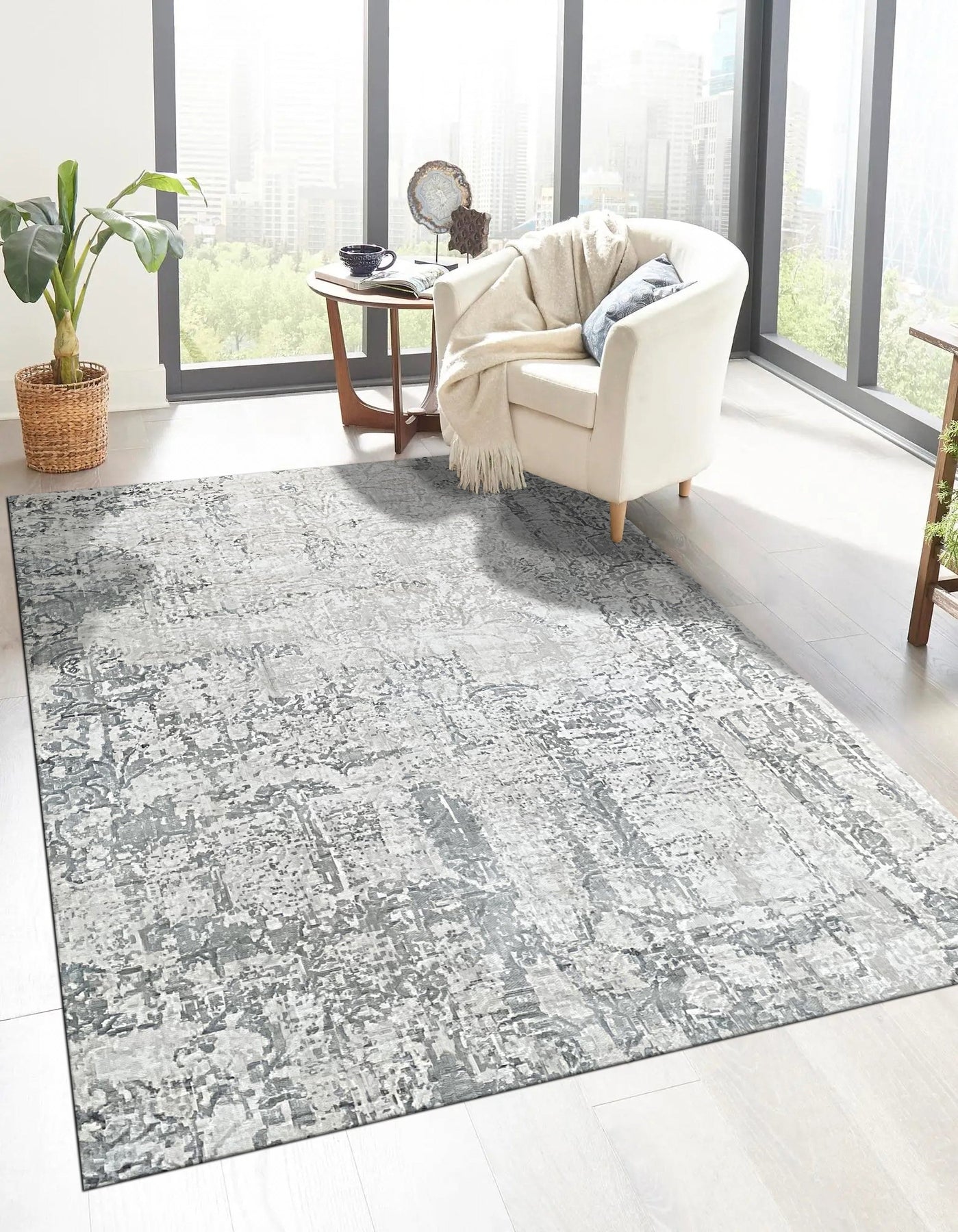 Sarrah Penelope Gray Hand Knotted Wool Rug, displaying intricate details and subtle patterns, resting in a bright living room setting.