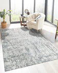 Sarrah Penelope Gray Hand Knotted Wool Rug, displaying intricate details and subtle patterns, resting in a bright living room setting.