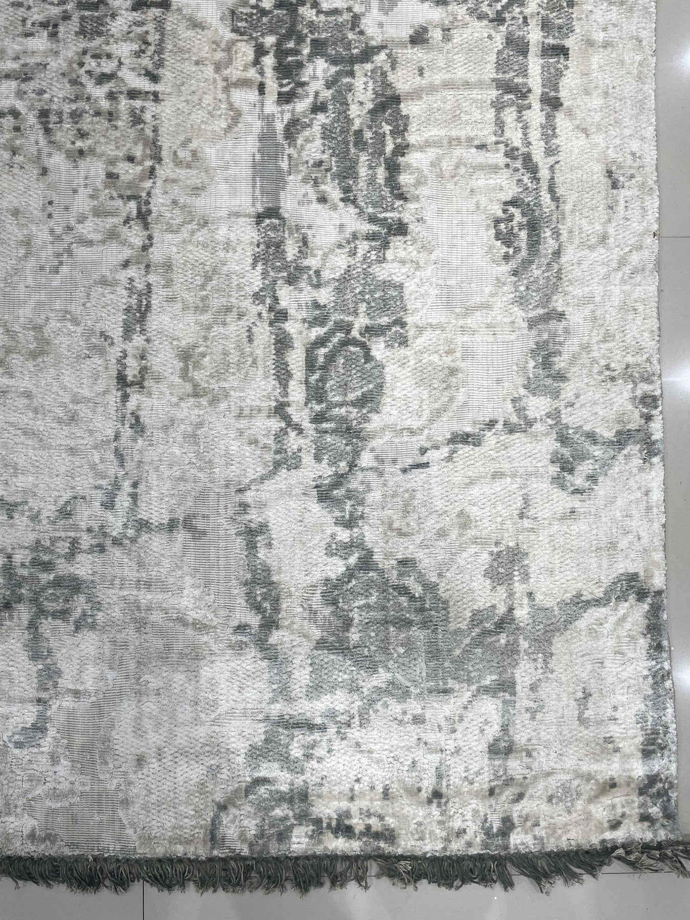 Sarrah Penelope Gray Hand Knotted Wool Rug, its intricate design unfolding across a living room floor, adding subtle warmth and texture to the space.