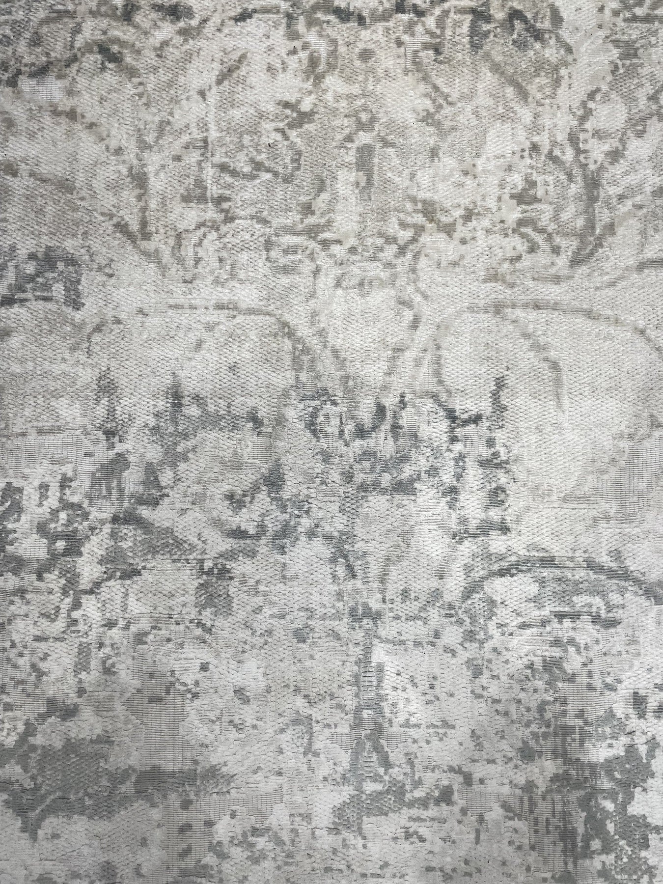 Sarrah Penelope Gray Hand Knotted Wool Rug, features subtle variations in light and dark gray wool yarns, displaying its hand-knotted construction and creating a calming, textured surface.