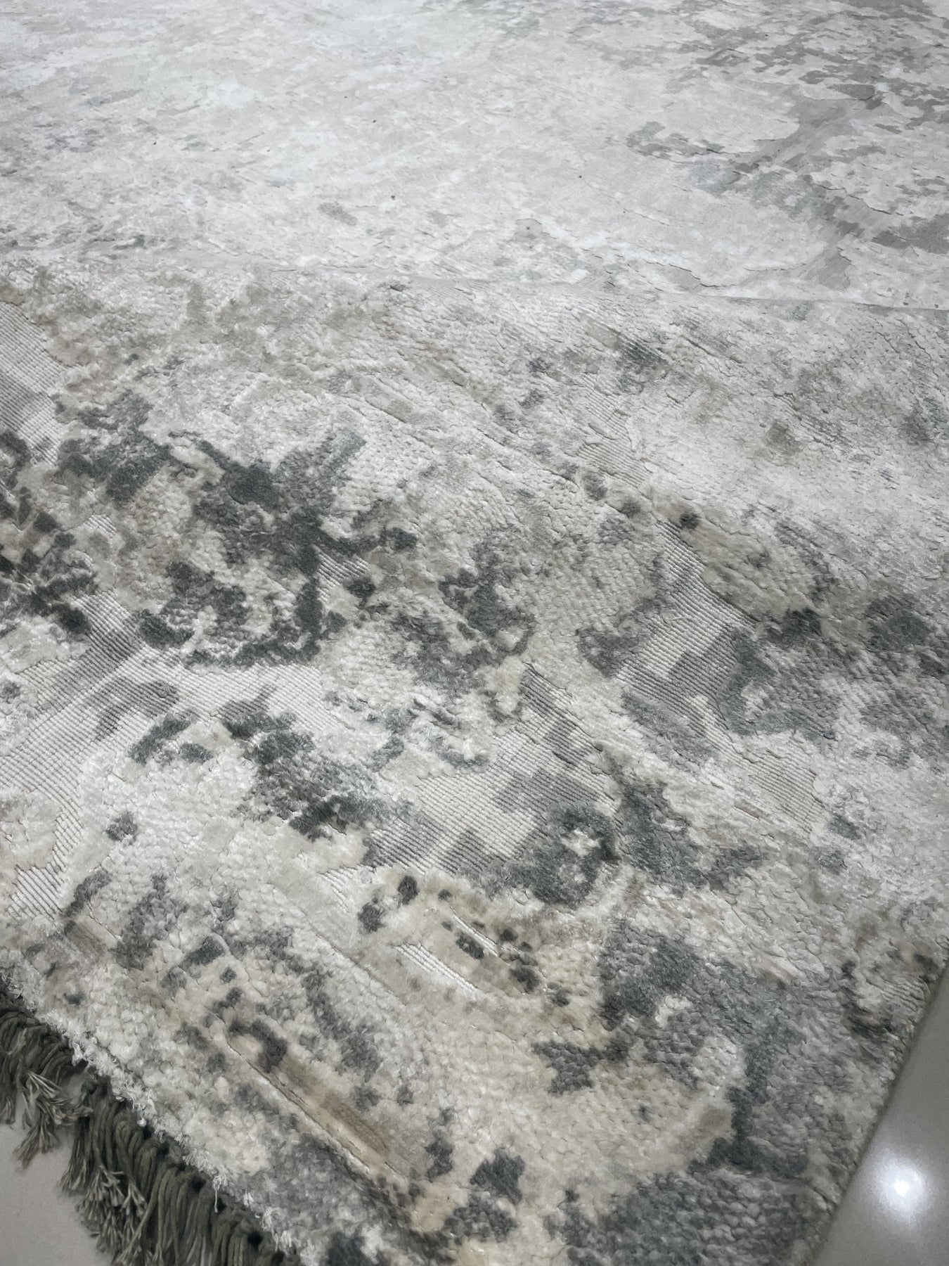 Sarrah Penelope Gray Hand Knotted Wool Rug displayed in a living room setting, showing its soft gray tones and intricate hand-knotted design complementing neutral furniture.