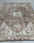 Elegant Versatile Coral Hand Knotted Wool Rug, a warm coral and cream hand-knotted wool rug with a subtle geometric design, displayed in a bright, modern living room setting.