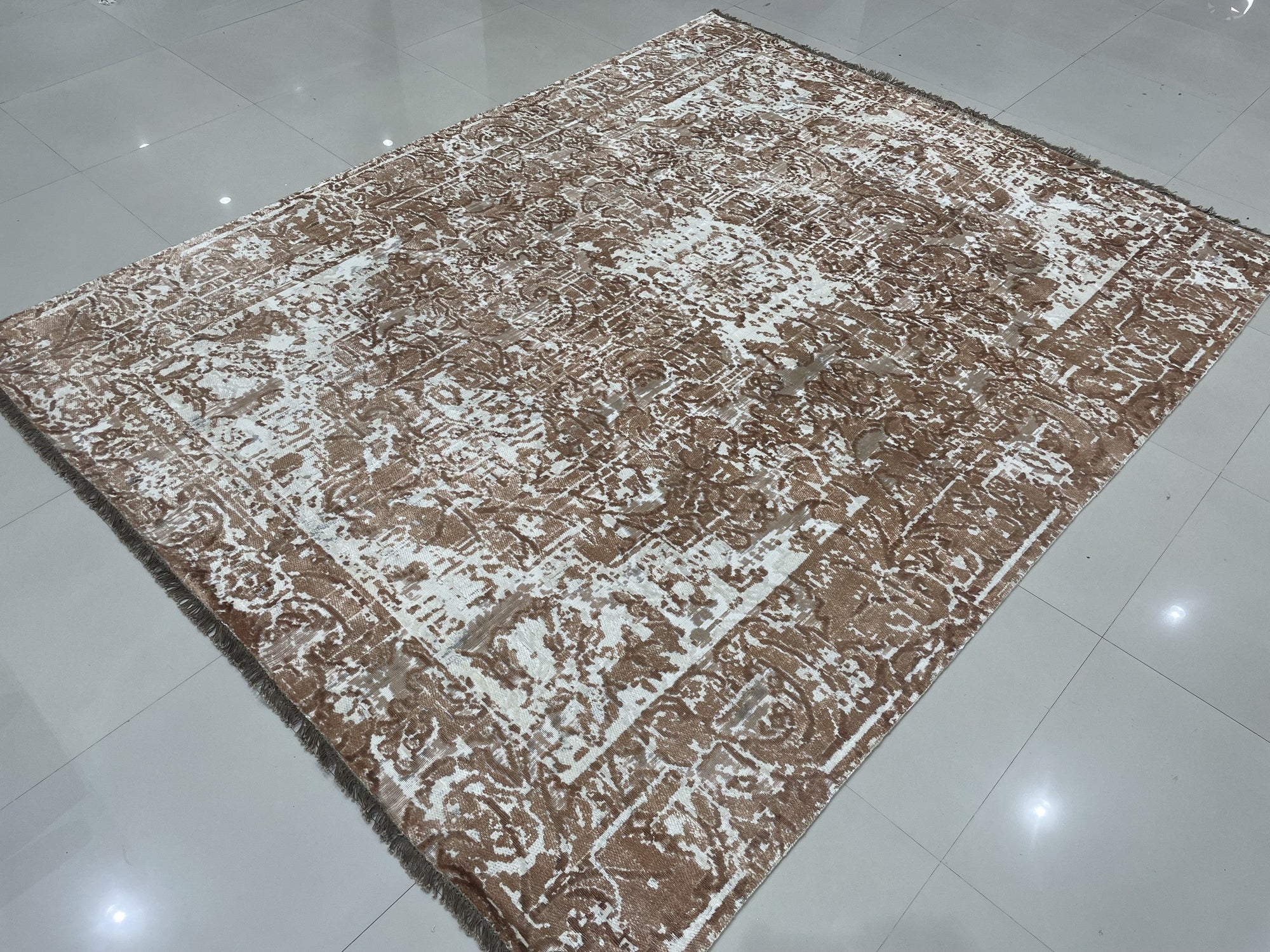 Elegant Versatile Coral Hand Knotted Wool Rug, displaying a subtly textured surface of blended coral and cream hues, the hand-knotted wool construction adding depth and a soft, inviting feel to the abstract design, seen in a lifestyle setting.