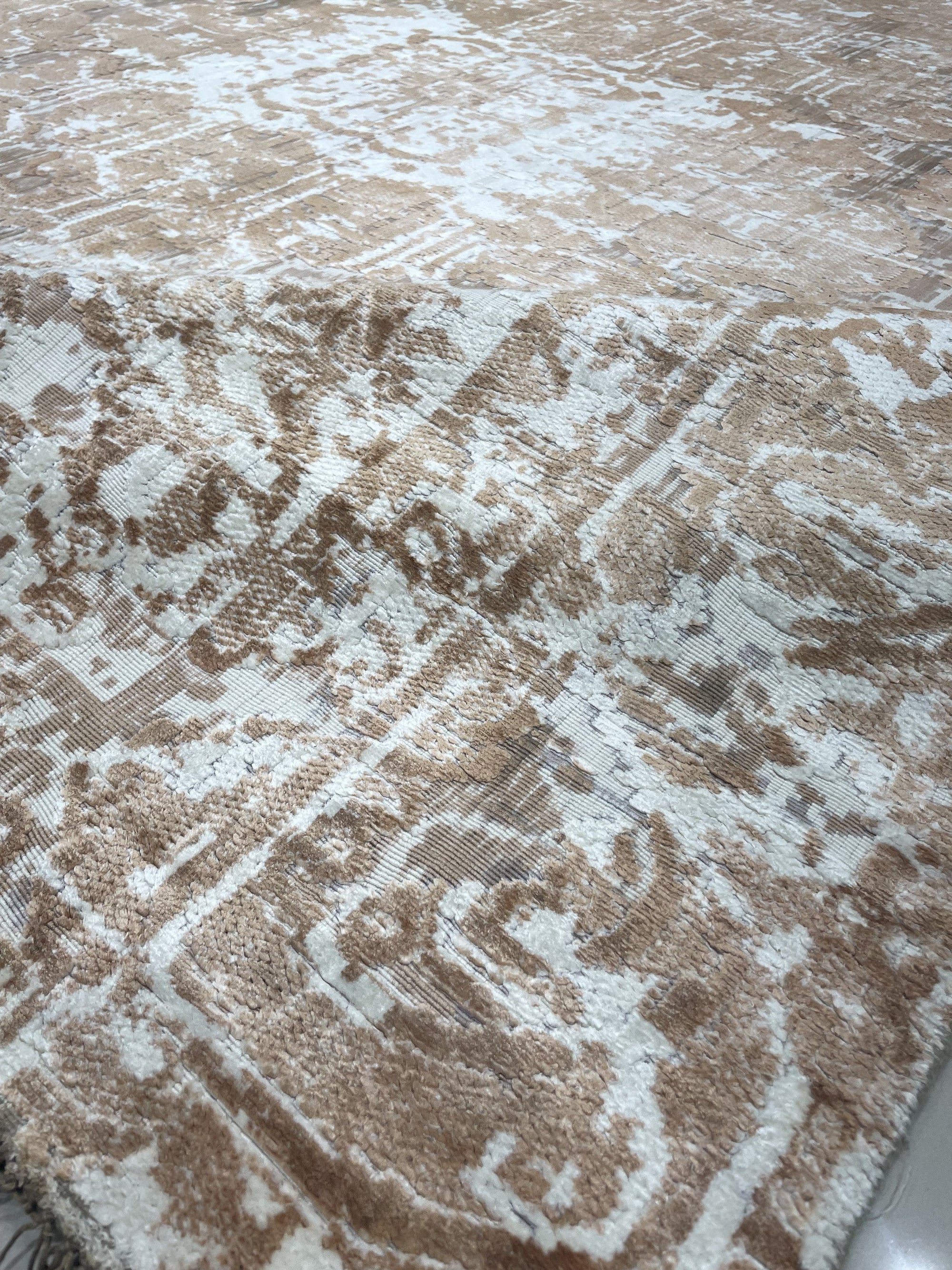 Elegant Versatile Coral Hand Knotted Wool Rug gracing a light wood floor, its vibrant coral hues and intricate hand-knotted details adding warmth and texture to the space.