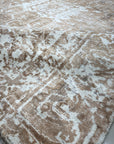 Elegant Versatile Coral Hand Knotted Wool Rug gracing a light wood floor, its vibrant coral hues and intricate hand-knotted details adding warmth and texture to the space.