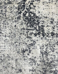 Luxurious Xena Gray Hand Knotted Wool Rug, a sophisticated gray wool rug with a subtle textured design, displayed in a bright, modern living room setting.