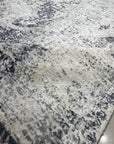Luxurious Xena Gray Hand Knotted Wool Rug, showcasing a subtle, textured gray design under soft lighting, hinting at its plush wool construction within a stylish interior.