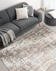 Brenda Isla Coral Hand Knotted Wool Rug, its intricate design rendered in warm coral hues, anchors a sun-drenched living room with hardwood floors and neutral furniture, suggesting comfortable sophistication.