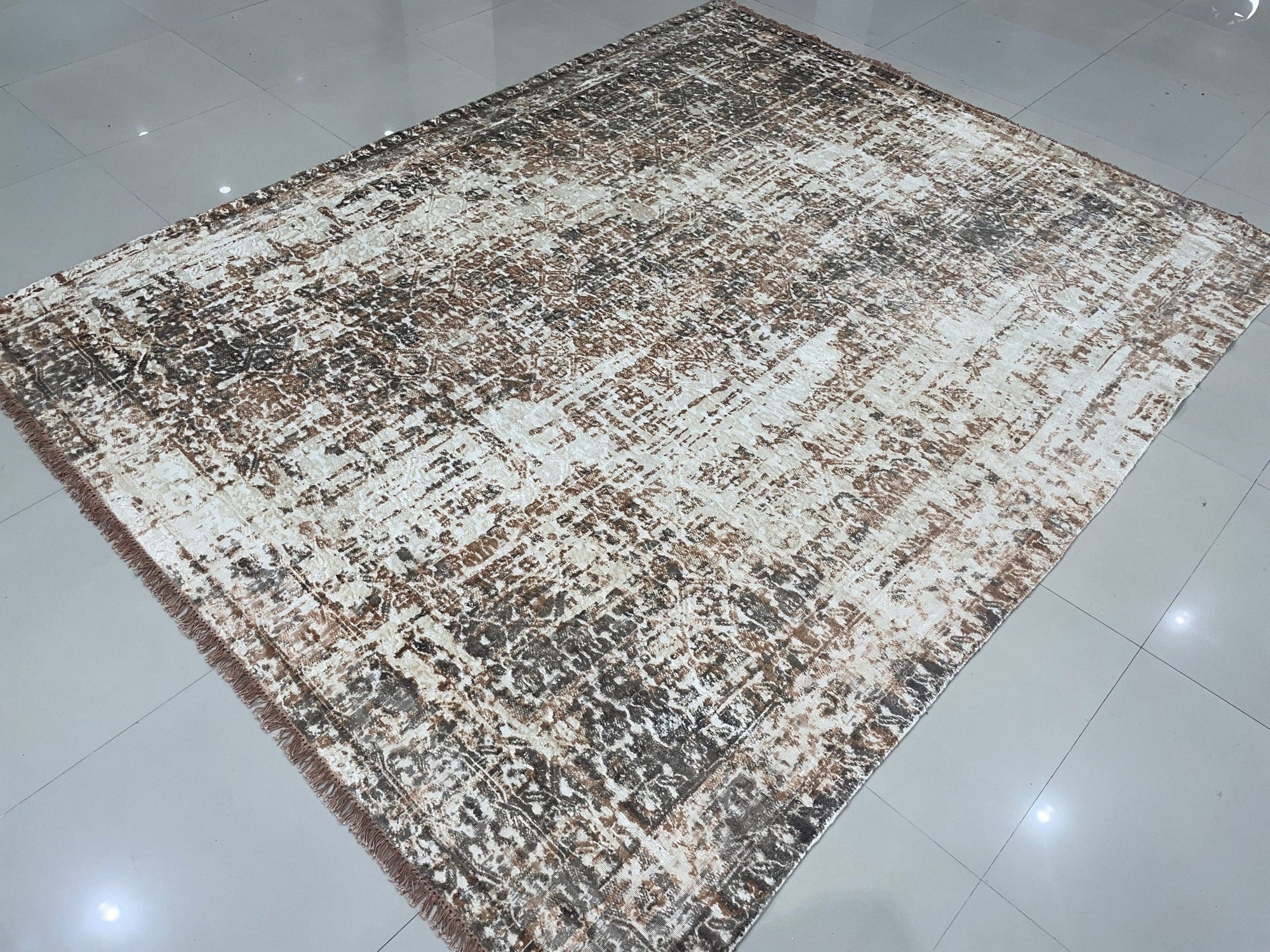 Brenda Isla Coral Hand Knotted Wool Rug, showcasing a vibrant blend of coral hues and intricate hand-knotted detailing, offers a warm and textured foundation in a stylishly furnished room.