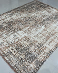 Brenda Isla Coral Hand Knotted Wool Rug, showcasing a vibrant blend of coral hues and intricate hand-knotted detailing, offers a warm and textured foundation in a stylishly furnished room.