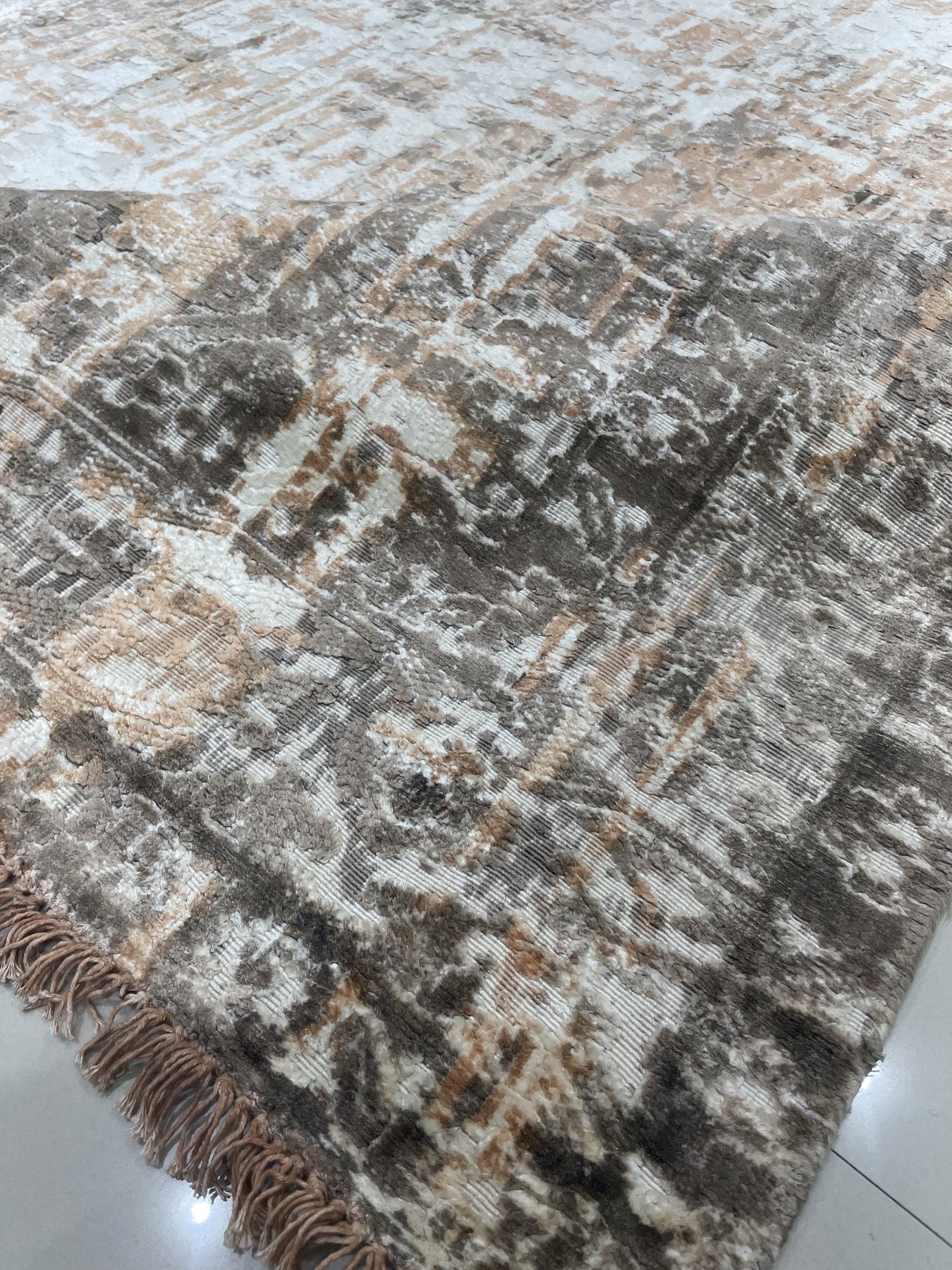 Brenda Isla Coral Hand Knotted Wool Rug, textural waves of coral hues ripple across a hand-knotted wool surface, grounding a bright, modern living space.