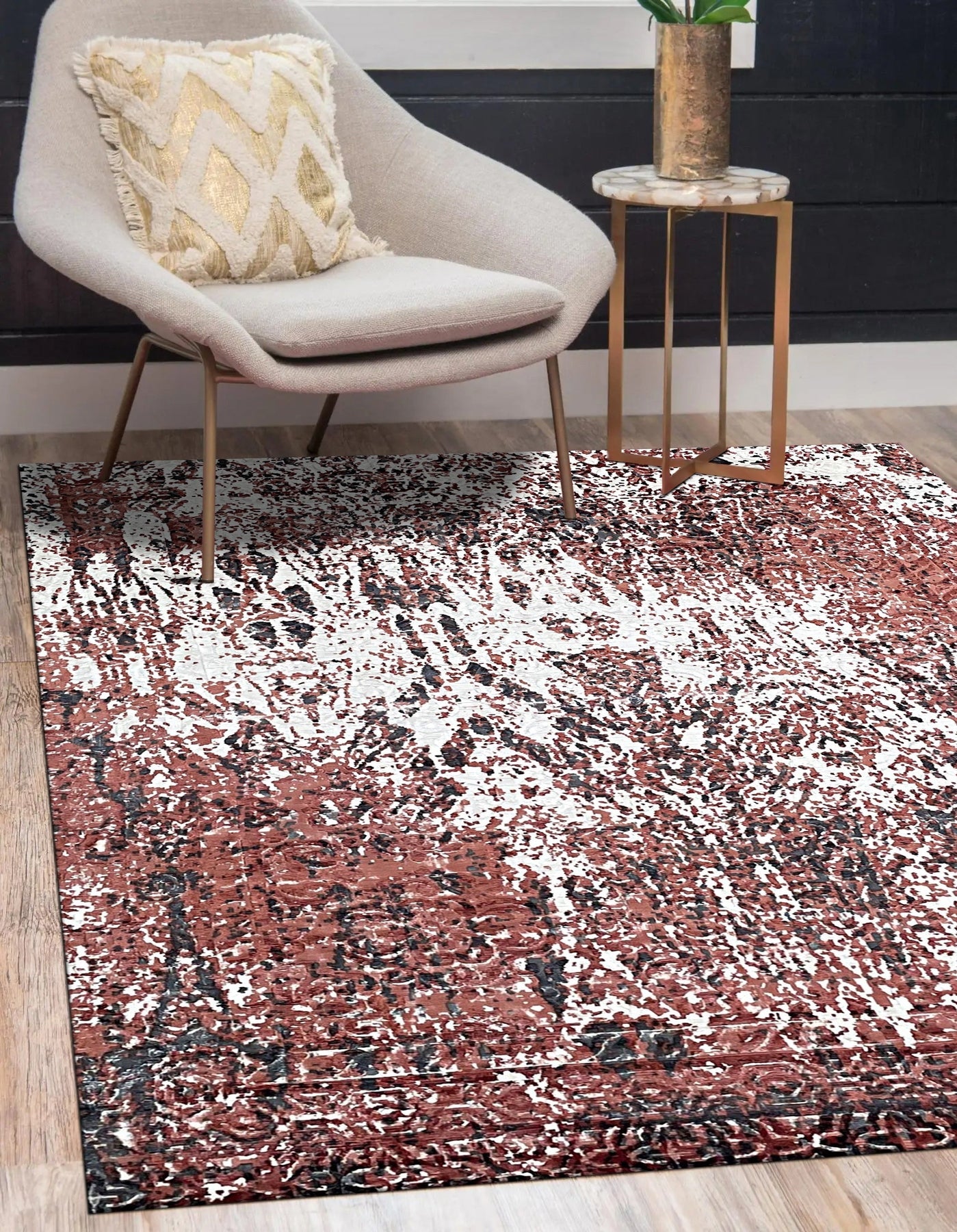 Ava Dahlia Red Hand Knotted Wool Rug, showcasing a vibrant floral pattern in warm red tones, lies gracefully on a light hardwood floor, its intricate hand-knotted construction evident in the texture and detail.