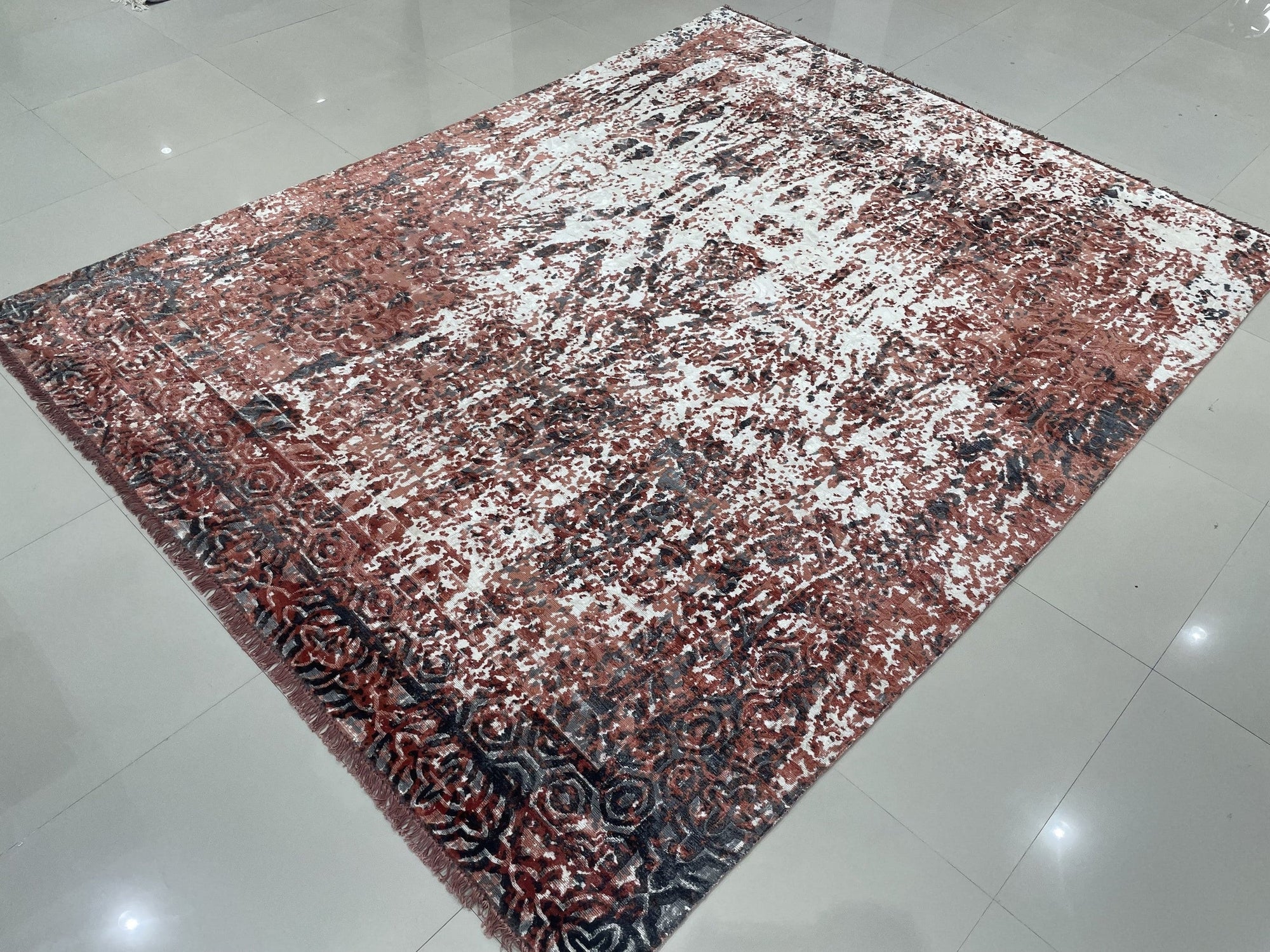 Ava Dahlia Red Hand Knotted Wool Rug, vibrant red and intricately patterned, laying flat with detailed floral motifs visible, showcasing its hand-knotted construction and luxurious texture.