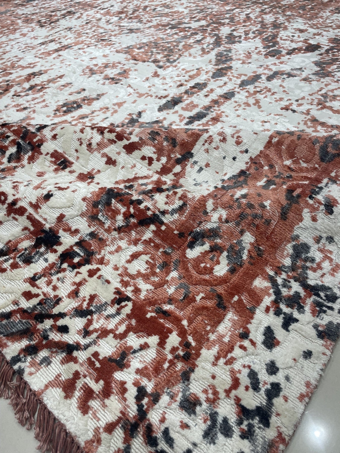 Ava Dahlia Red Hand Knotted Wool Rug, featuring a vibrant red floral pattern hand-knotted from wool, presented in a room setting with furniture.