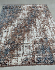 Charming Modern Coral Hand Knotted Wool Rug, a warm coral and ivory wool rug with a contemporary geometric pattern, staged in a bright, modern living room setting.