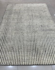 Graceful Vibrant Ivory Hand Knotted Wool Rug, a luxurious ivory wool rug with intricate hand-knotted detailing, adds warmth and texture to a room setting.