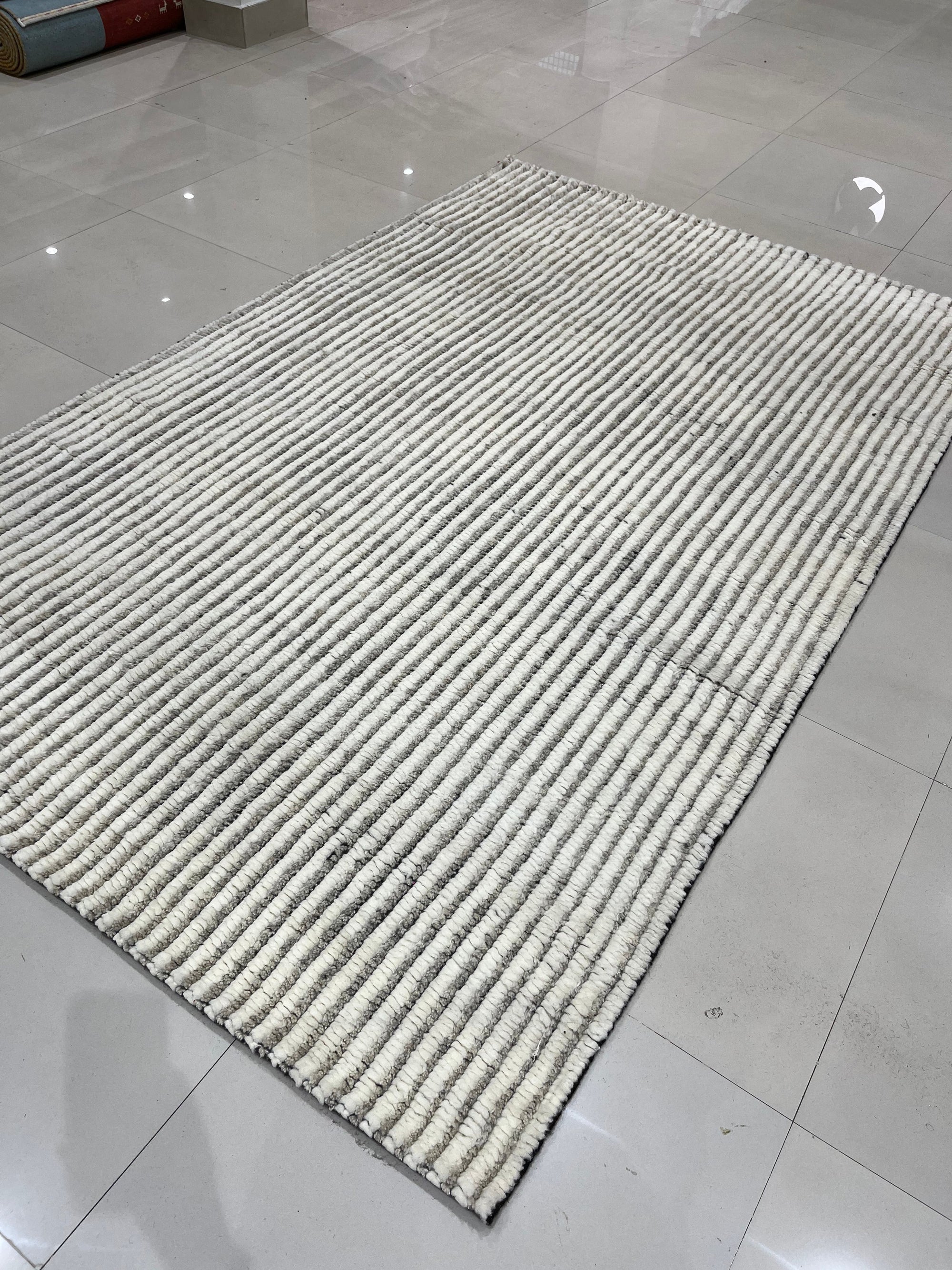 Graceful Vibrant Ivory Hand Knotted Wool Rug, luxurious ivory texture and hand-knotted construction displayed in a warmly lit interior setting.
