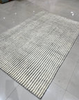 Graceful Vibrant Ivory Hand Knotted Wool Rug, luxurious ivory texture and hand-knotted construction displayed in a warmly lit interior setting.