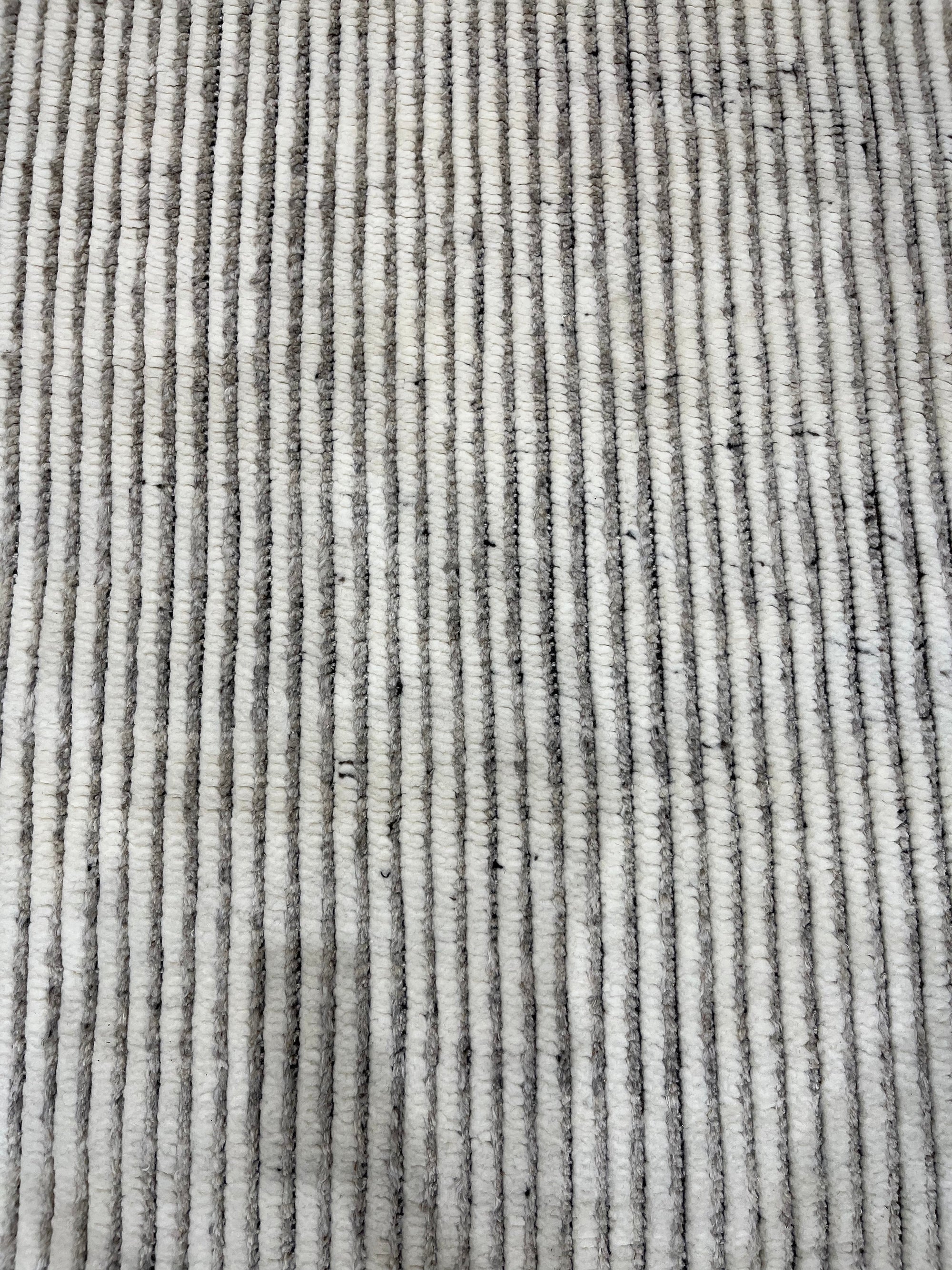 Graceful Vibrant Ivory Hand Knotted Wool Rug, textured ivory wool hand-knotted rug with subtle variations, enhancing a warm and inviting atmosphere.