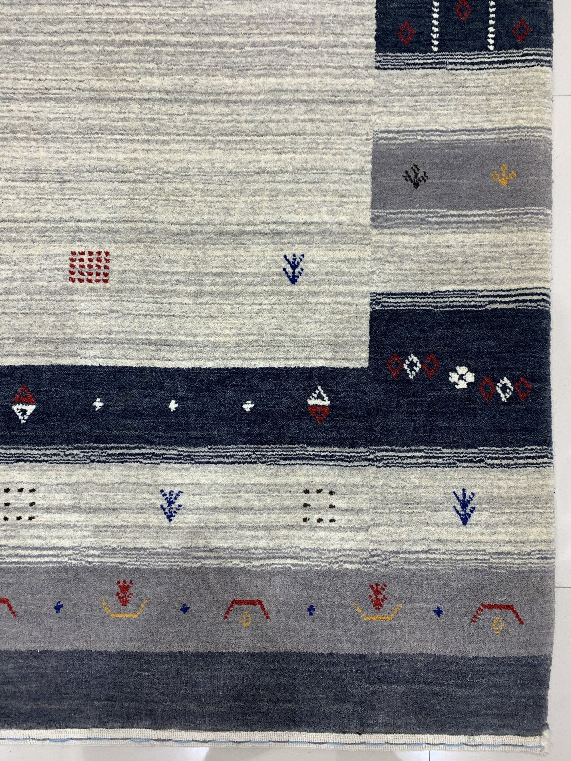 Radiant Gabbeh Multicolor Handmade Wool Rug, showcasing a vibrant, abstract design with thick, textured wool in a well-lit living room setting.