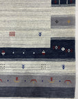 Radiant Gabbeh Multicolor Handmade Wool Rug, showcasing a vibrant, abstract design with thick, textured wool in a well-lit living room setting.