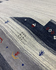Radiant Gabbeh Multicolor Handmade Wool Rug, bursting with vibrant hues and geometric designs, laying flat to display its colorful wool construction and handcrafted details.