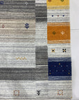 Classic Gabbeh Multicolor Hand Knotted Wool Rug, displaying vibrant bands of earthy tones, from deep reds and browns to warm yellows and greens, intricately hand-knotted with characteristic Gabbeh simplicity and texture.