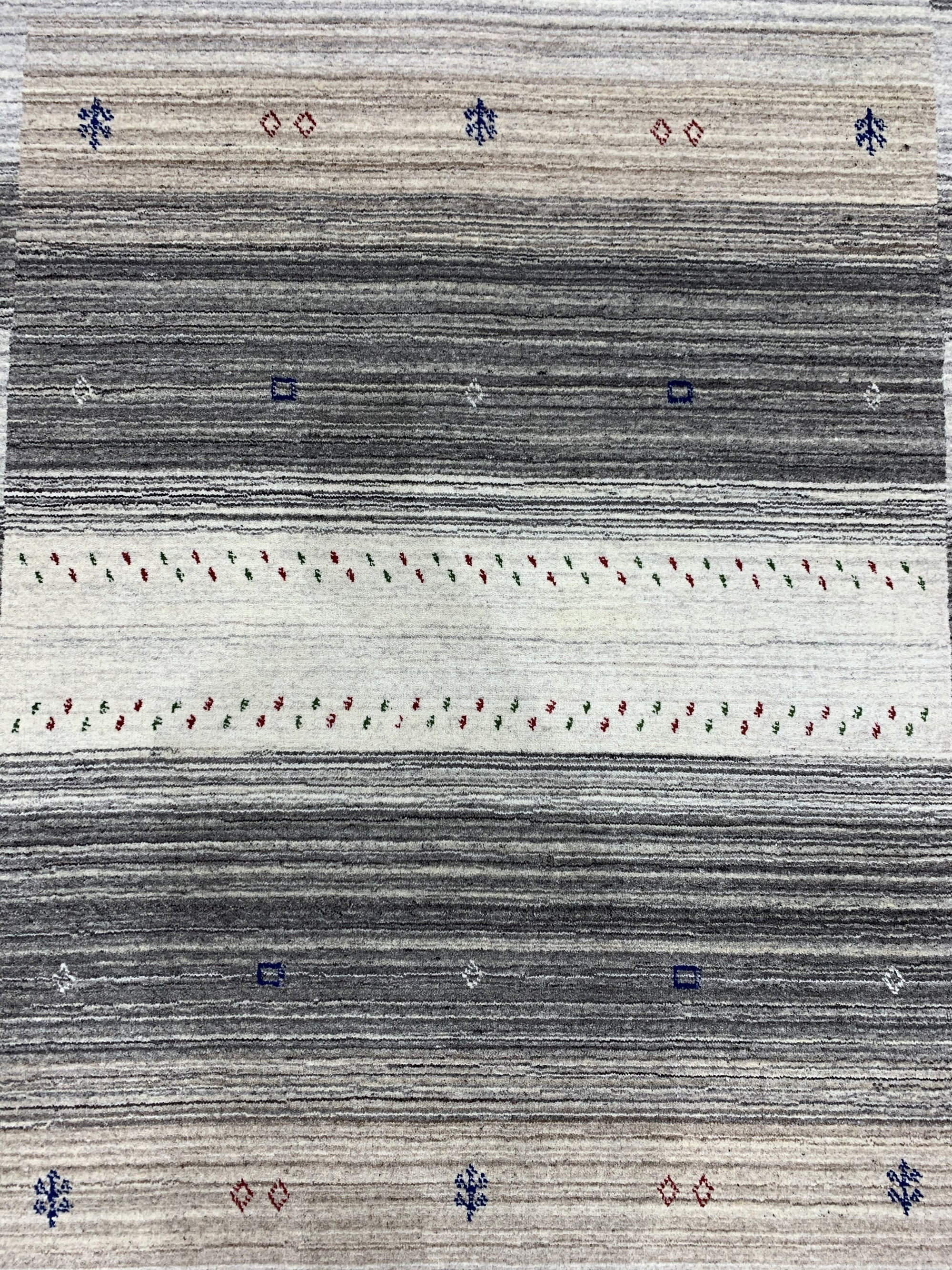 Classic Gabbeh Multicolor Hand Knotted Wool Rug, showcasing vibrant, hand-knotted wool with a traditional Gabbeh design featuring geometric patterns in reds, blues, yellows, and greens, spread across a light background.