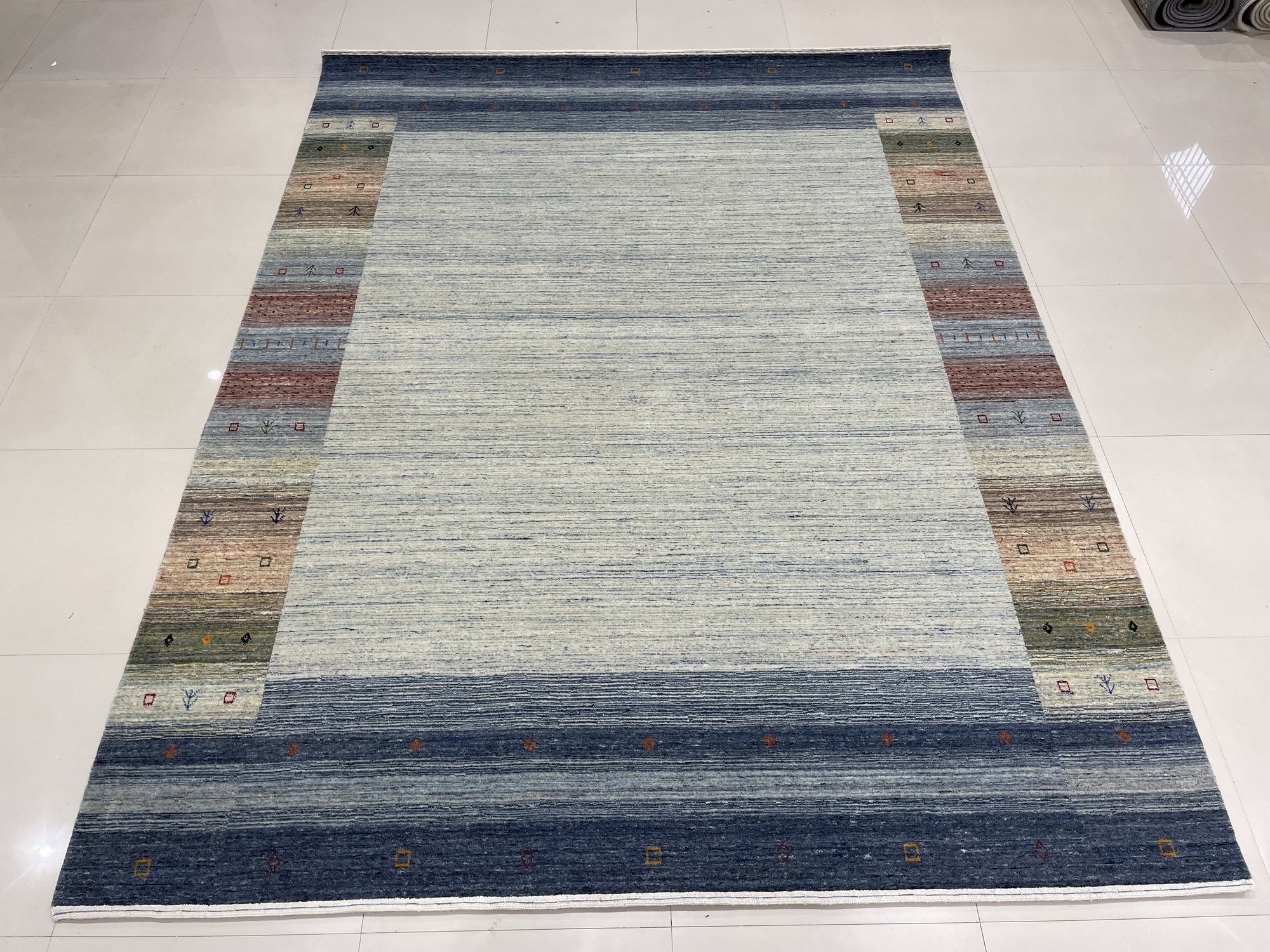 Since the image position is 6, the alt text should follow the second set of instructions.
 
 Chic Gabbeh Gray Handmade Wool Rug, its subtle geometric design adds texture to this minimalist space, the hand-knotted wool creating a soft, inviting feel.