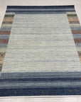 Since the image position is 6, the alt text should follow the second set of instructions.
Chic Gabbeh Gray Handmade Wool Rug, its subtle geometric design adds texture to this minimalist space, the hand-knotted wool creating a soft, inviting feel.
