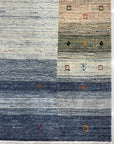 Chic Gabbeh Gray Handmade Wool Rug, its textured gray wool construction adding warmth and subtle pattern to a brightly lit interior.
