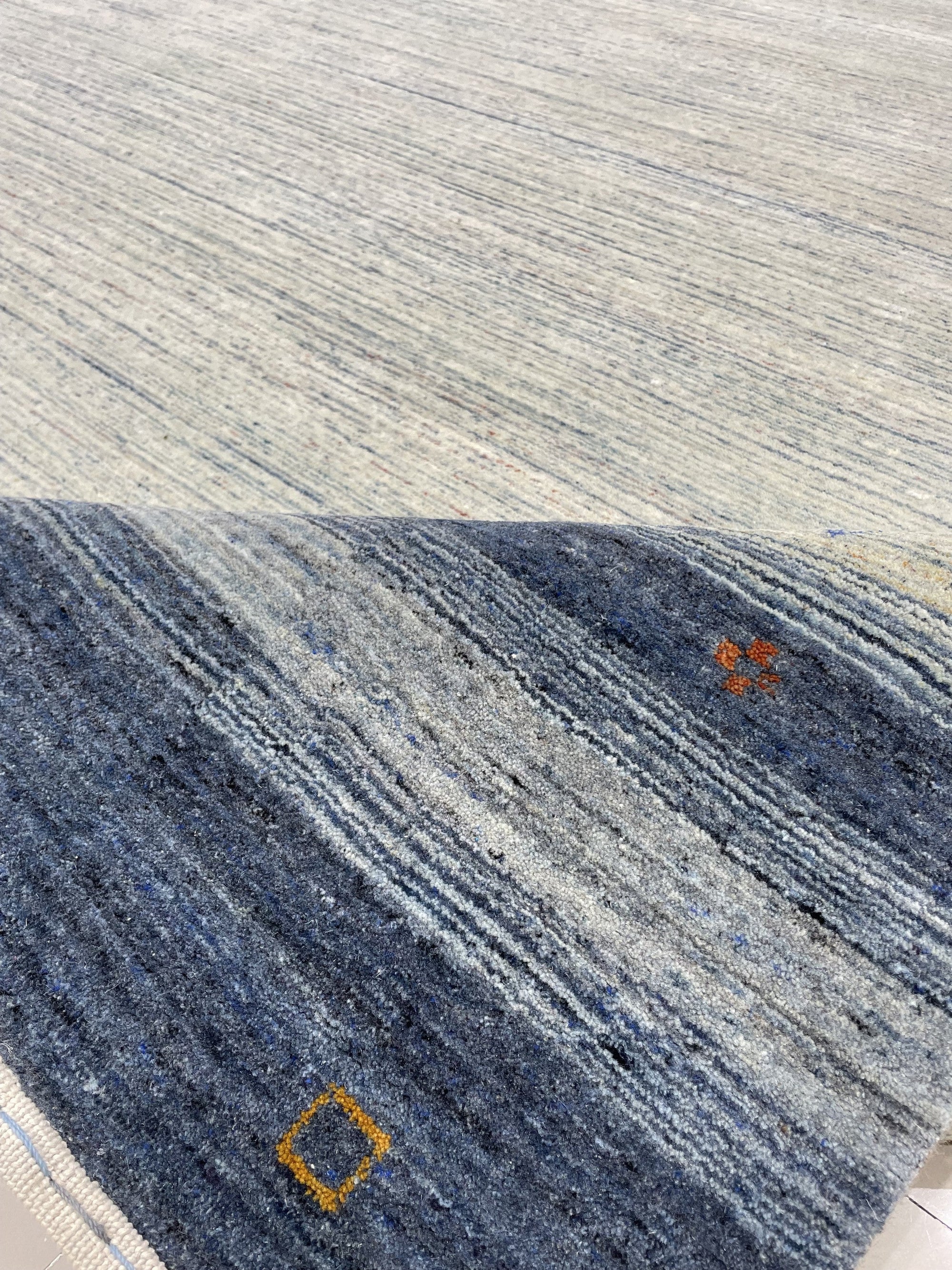 Chic Gabbeh Gray Handmade Wool Rug, its soft, striated grays lending subtle texture to a well-lit living space.