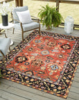 Elegant Traditional Rust Hand Knotted Wool Rug, displaying intricate floral motifs and geometric borders in warm rust tones, lies flat on a light surface, highlighting its handcrafted construction and rich color palette.