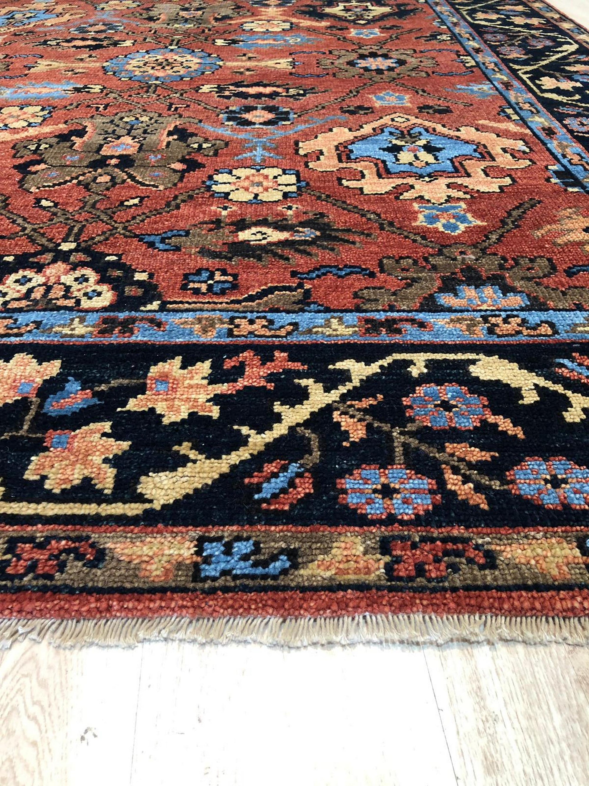 Hand-knotted wool rug in rust tones, the Elegant Traditional Rust Hand Knotted Wool Rug displaying intricate traditional patterns, filling the frame with warmth and classic design.